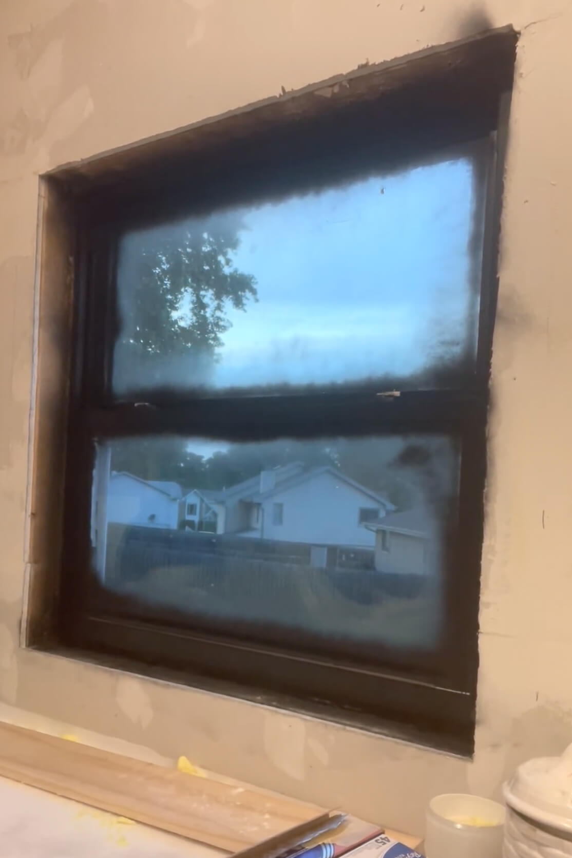 Use spray paint to make windows black.